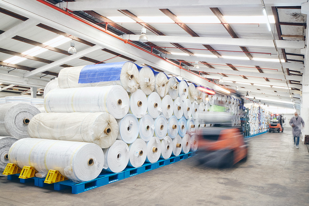 A stack of rolled polypropylene fabric in the IPP warehouse.
